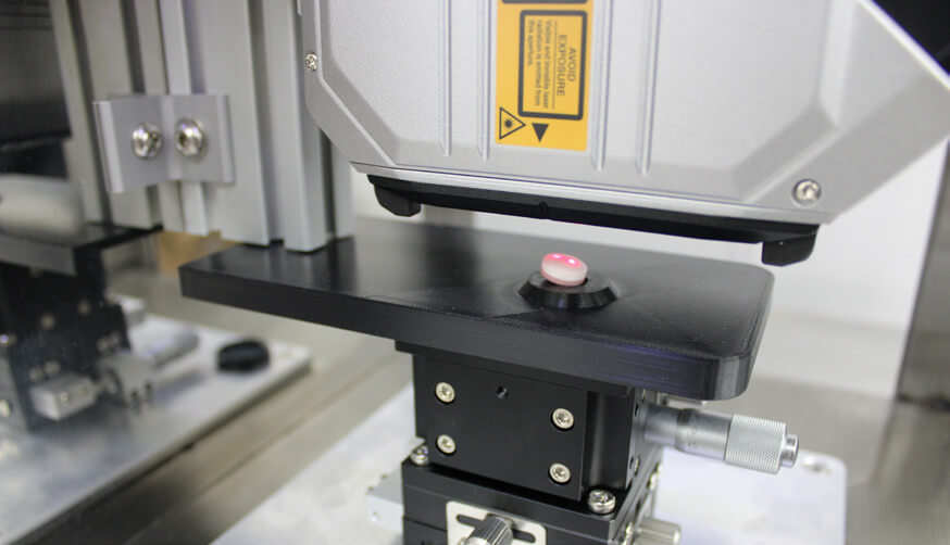 Close-up of a LDI system laser drilling a tablet