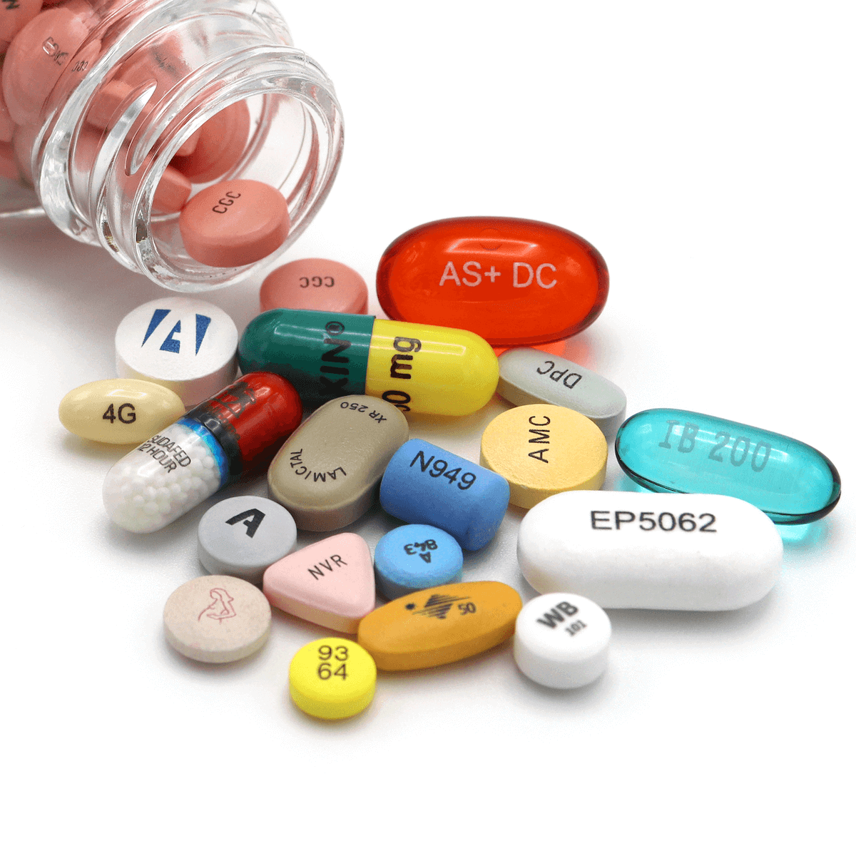 A variety of colorful prescription pills and capsules, highlighting Ackley Hartnett capabilities, are spilled from a bottle onto a white background. The pills display different shapes, colors, sizes, and visible imprints or codes.